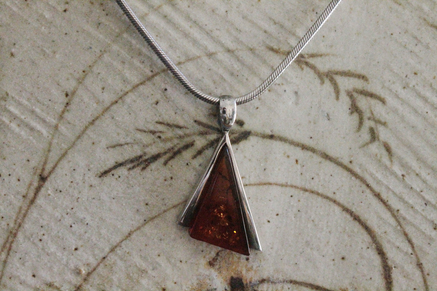 Asymmetrical amber sterling silver pendant